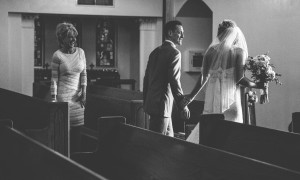 bride and groom walk the isle