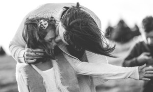 mother kisses daughter windblown hair