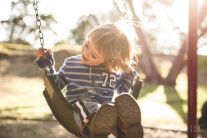 little boy swinging in the sun (austin children's photographer)