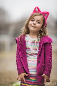 5 year old girl in rainbow clothes and pink kitty ears