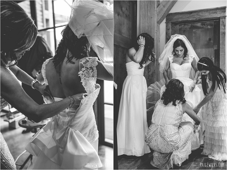 bridesmaids help bride into wedding dress