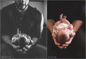 father cradles newborn in hands