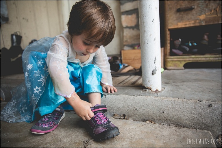 little boy in elsa dress and pink sparkle shoes