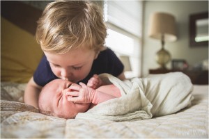 brother kisses baby brother