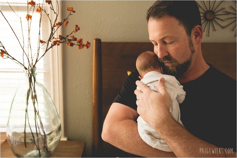 new father cradles infant