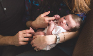 newborn alert holding hands natural light photography