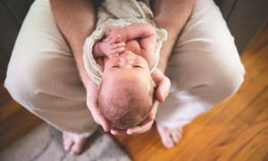 father cradles newborn austin photography